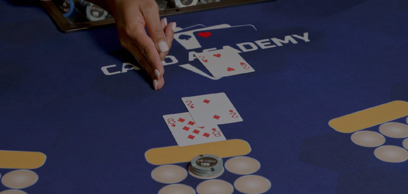 Human and card hands on table